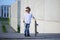 A portrait of defiant boy with skateboard outdoors.