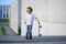 A portrait of defiant boy with skateboard outdoors.