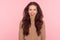 Portrait of delighted young woman with brunette wavy hair looking at camera with extremely happy joyful smile