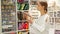 Portrait of delighted young woman with colorful ribbons for sewing in haberdasher shop