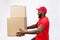 Portrait of delivery african american man in red shirt. he lifting heavy weight boxes against having a isolated on the