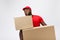 Portrait of delivery african american man in red shirt. he lifting heavy weight boxes against having a isolated on the