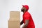 Portrait of delivery african american man in red shirt. he lifting heavy weight boxes against having a isolated on the