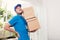 Portrait of delivery asian man with hands holding cardboard box