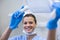 Portrait of dental assistant adjusting light