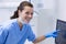 Portrait of dental assistant examining an x-ray on the monitor