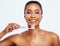 Portrait, dental and a black woman brushing teeth in studio isolated on a white background for oral hygiene. Face