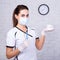 Portrait of dentist woman holding teeth model and tools