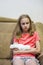 Portrait of Depressed Caucasian Blond Girl with Injured Hand In Plaster