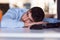 Portrait of a depressed office worker laying on his desk and thinking