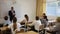 Portrait of diligent teenager schoolboy answering at board to teachers question in front of group of students in