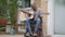 Portrait of disabled African American musician guitarist in wheelchair sitting on porch with guitar touching strings