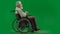 Portrait of disabled man isolated on chroma key green screen full shot. Senior bearded man sitting in wheelchair holding