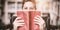 Portrait of disabled schoolboy holding book in library