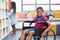 Portrait of disabled schoolboy on wheelchair in library