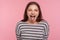 Portrait of disobedient funny woman in striped sweatshirt showing tongue out, expressing displeasure, teasing