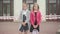 Portrait of dissatisfied Caucasian schoolgirls standing in front of school closed with barricade tape and looking at