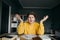 Portrait of a dissatisfied teen student in bright casual clothes sitting with books and notebooks at a table in a cozy bedroom at