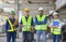 portrait diverse engineers team standing and looking at camera while working in the building under construction