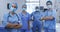 Portrait of diverse female and male surgeons wearing face masks and scrubs in hospital