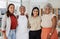 Portrait of a diverse group of smiling ethnic business women standing together in the office. Ambitious happy confident