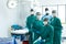 Portrait of diverse group of smiling surgeons in masks in operating theatre, copy space