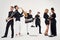 Portrait of diverse group of young people musical band playing with instruments -  on white background.