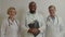 Portrait of diverse multiethnic medical colleagues looking with friendly smiles at hospital