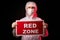 Portrait of doctor male in protective medical suit holding tablet with RED ZONE inscription