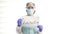 Portrait of a doctor in a protective suit with a poster QUARANTINE.