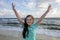 Portrait of down syndrome girl smiling on background of the sea