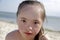 Portrait of down syndrome girl smiling on background of the seaÑŽ