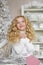 Portrait of dreaming blonde little girl in Christmas decorated studio