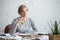 Portrait of a dreaming student woman at the desk