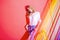 Portrait of Dreaming Tranquil Female Woman Posing on Red Behind Colorful Thread Stripes