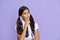 Portrait of dreamy latin schoolgirl isolated on violet background.