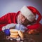 Portrait of dreamy Santa Claus looking at delicious sweet donuts