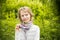 Portrait of dreamy thoughtful girl over greenery background