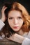 Portrait of dreamy young beautiful redhead woman relaxing at home