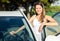 Portrait of driver caucasian woman next to car