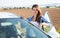 Portrait of driver caucasian woman next to car