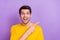 Portrait of ecstatic funny man promote recommend product huge bargains isolated on purple color background