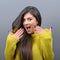 Portrait of a ecstatic woman with spread hands against gray background