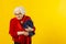 Portrait of an elder woman against a yellow background