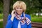 Portrait of an elderly beautiful woman talking on a cell phone