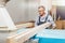 Portrait of an elderly carpenter or carpenter working with wooden boards in a carpenter's workshop.