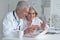 Portrait of an elderly couple of doctors at the laptop