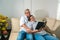 Portrait of an elderly couple with glasses reading their favorite books while on the couch