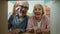 Portrait of elderly couple opening carton box looking inside then at each other