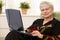Portrait of elderly lady with computer